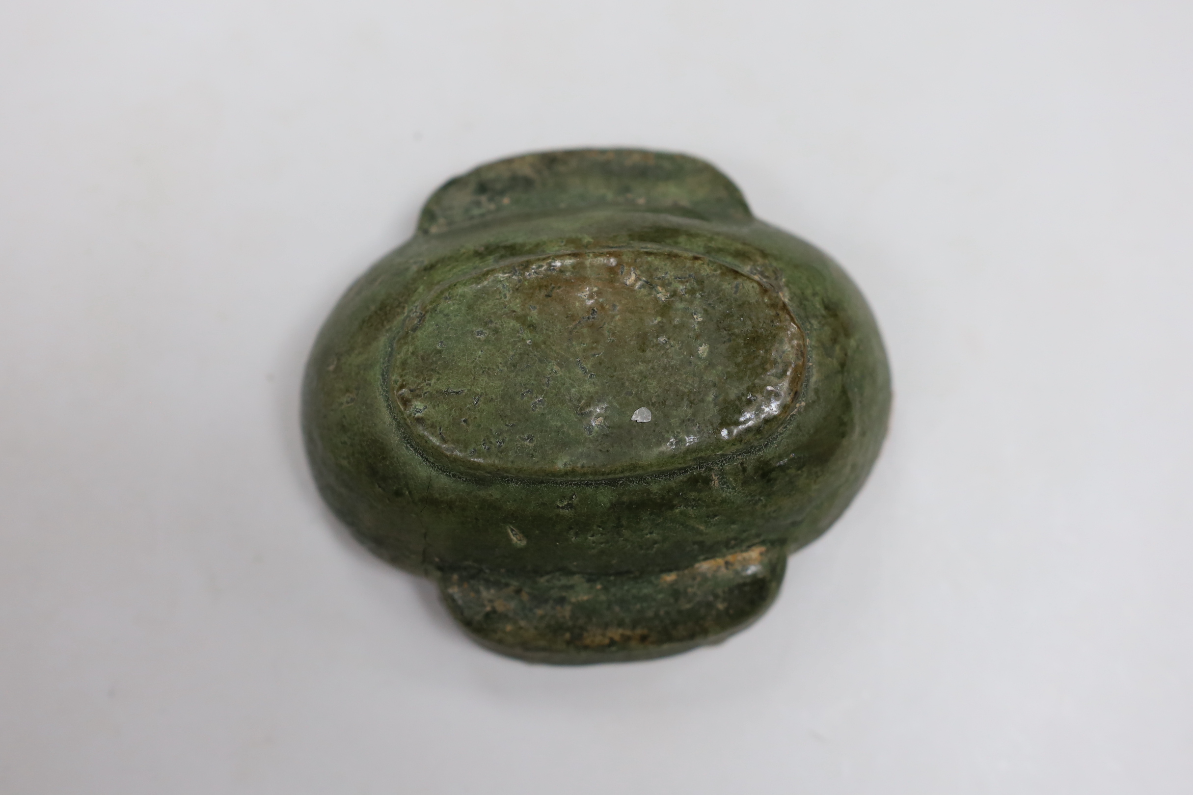 A Chinese Han dynasty green glazed stoneware ear cup, 9cm wide, 10cm long